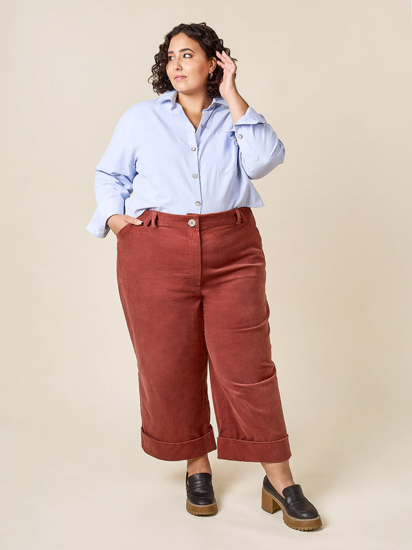 Plus-size sewn sample of the Rika pants sewing pattern by Closet Core Patterns in rust corduroy, front view with cuffed hems.