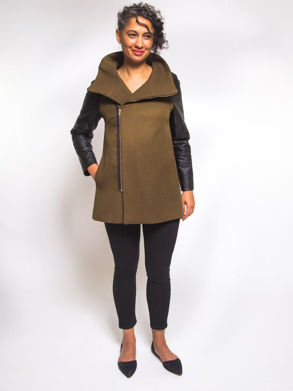 Sewn sample of the Clare coat sewing pattern by Closet Core Patterns in olive wool with black sleeves, front view, asymmetrical zipper.