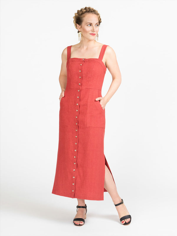 Sewn sample of the Fiona sundress sewing pattern by Closet Core Patterns in rust red linen, front view with button front and patch pockets.