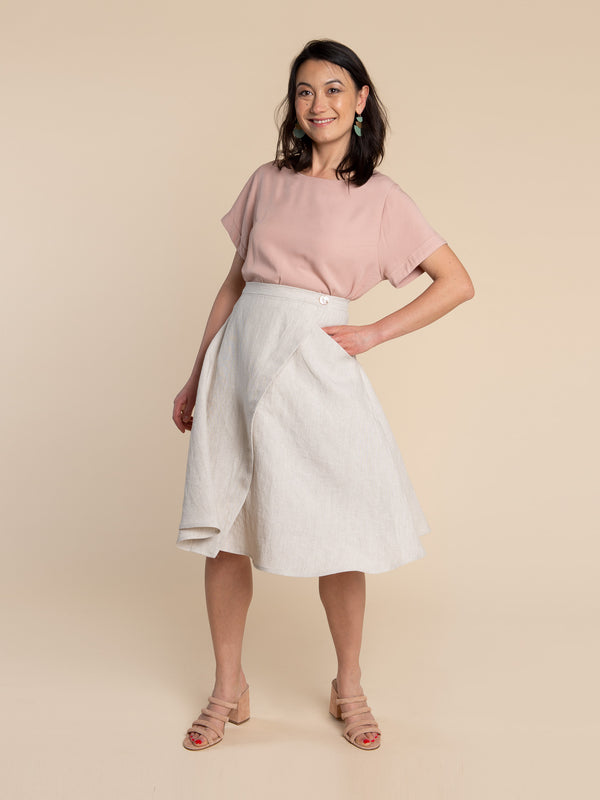 Sewn sample of the Fiore skirt sewing pattern by Closet Core Patterns in natural linen, front view of the wrap skirt with button waist.