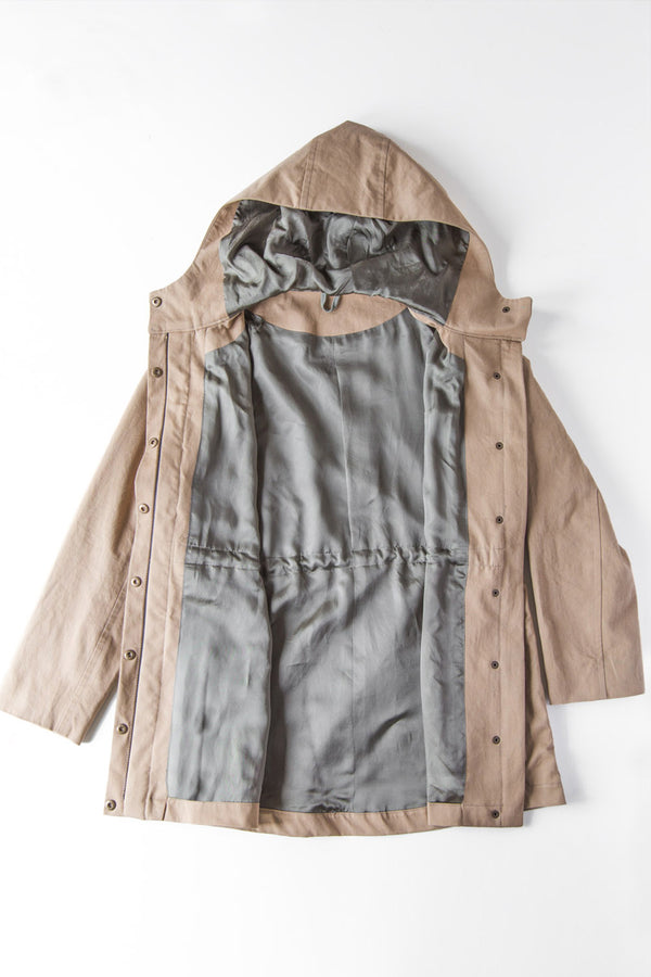 Sewn sample of the Kelly anorak lining sewing pattern by Closet Core Patterns in tan, laid flat open with grey lining and hood.