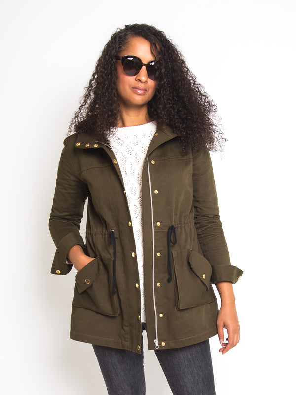 Sewn sample of the Kelly anorak jacket sewing pattern by Closet Core Patterns in olive green with drawstring waist and flap pockets.