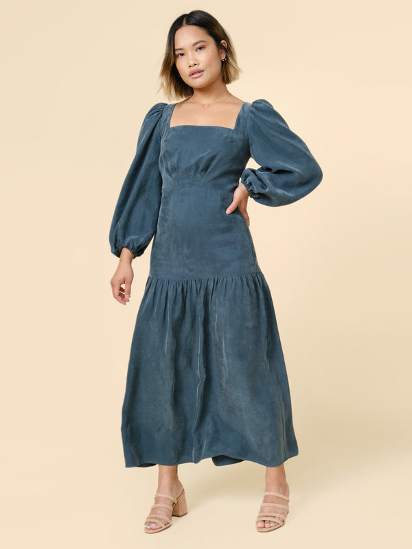Sewn sample of the Pauline dress sewing pattern by Closet Core Patterns in teal blue, front view with puff sleeves and square neckline.