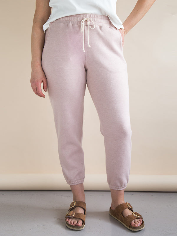 Sewn sample of the Plateau joggers sewing pattern by Closet Core Patterns in dusty pink knit with drawstring waist, front view.