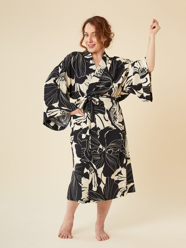 Sewn sample of the Veronik robe sewing pattern by Closet Core Patterns in black and cream floral print, front view with tie belt.